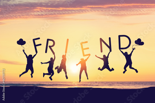 Silhouette friends jumping and holding summer words on sunset sky abstract background at tropical beach. Travel holiday and freedom feel good concept.