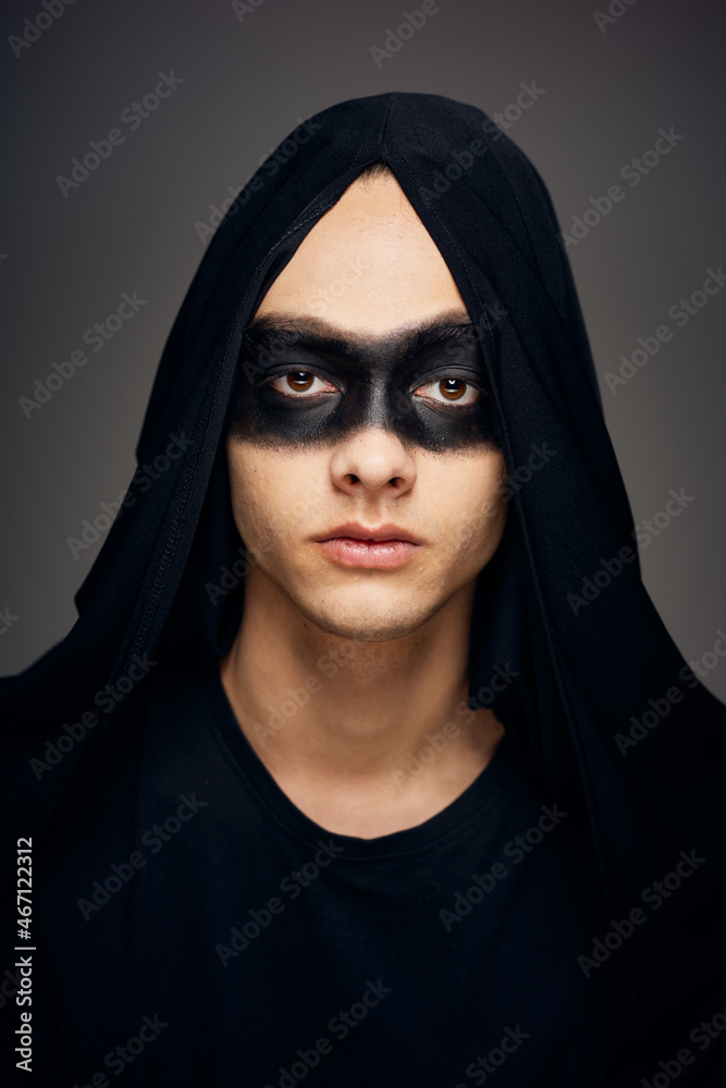 a man in a black mask Halloween costume ghost dark background a man in a black mask Halloween costume ghost dark background