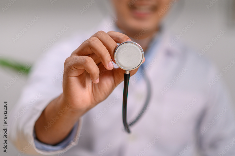 a doctor using a stethoscope to check a patient's heart a doctor using a stethoscope to check a patient's heart