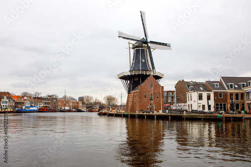 Cityscape of Haarlem, the Netherlands. View of old windmill and typical Dutch houses.