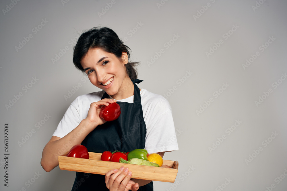 housewife in a black apron with vegetables healthy food cooking housewife in a black apron with vegetables healthy food cooking