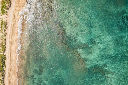 Top Down view into Teal water from beautiful Hawaiian Island of Maui with white sand beach