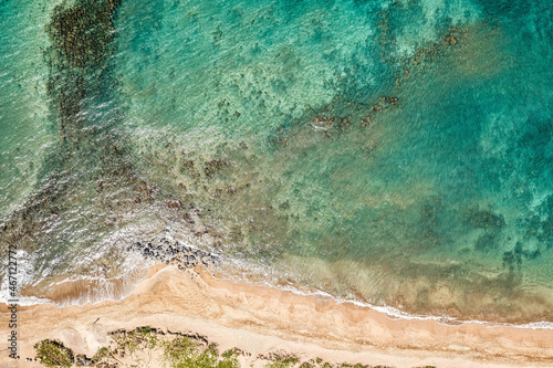 Top Down view into Teal water from beautiful Hawaiian Island of Maui with white sand beach