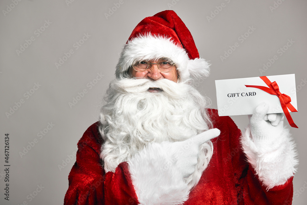 Santa Claus holding gift card in hands