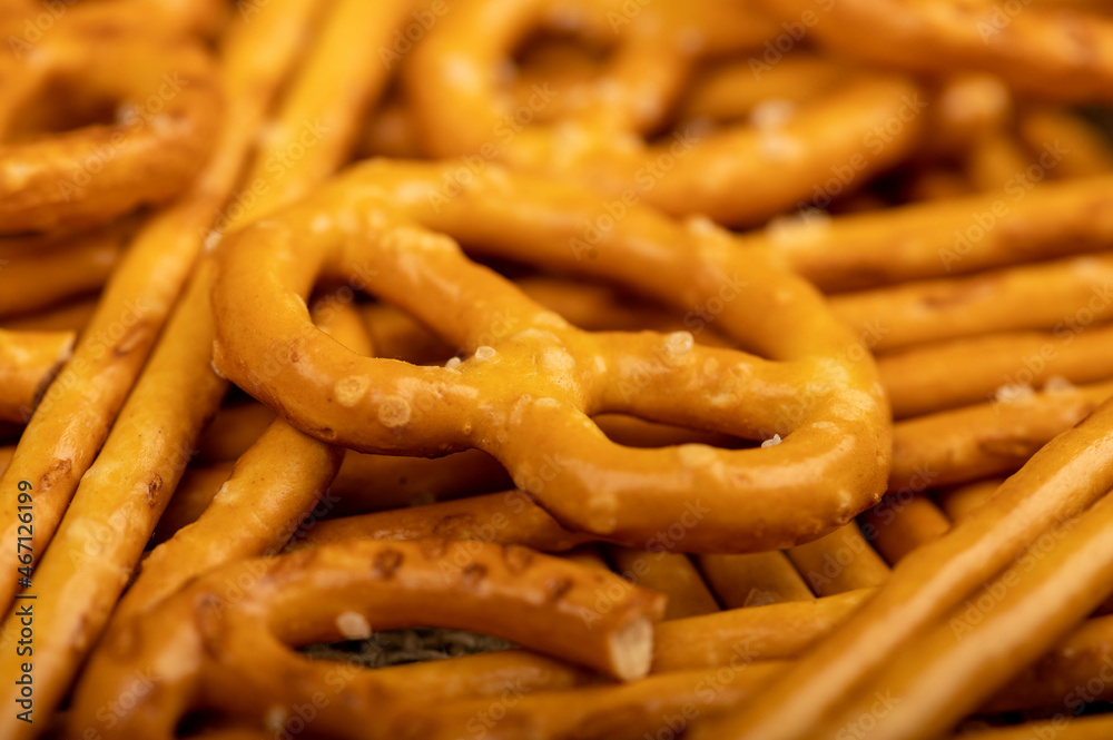 Crispy bread straws with salt, close-up, selective focus, top view.