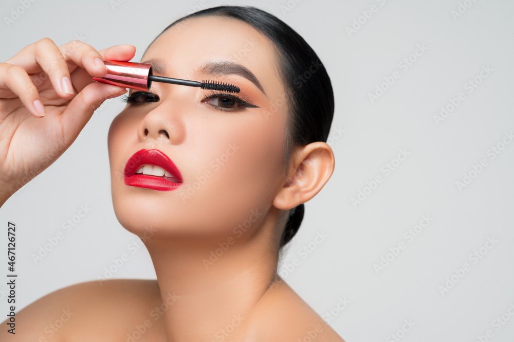 Portrait of Beautiful Asian woman with mascara in hand