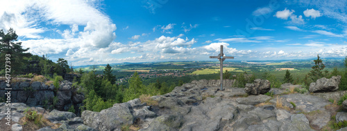 Panoramic view from Tempelwand sandstone viewpoint with wooden cross on hill Topfer, Oybin with view of Zittau and Poland German borders in Zittauer Gebirge mountains, Saxony, germany. Summer sunny