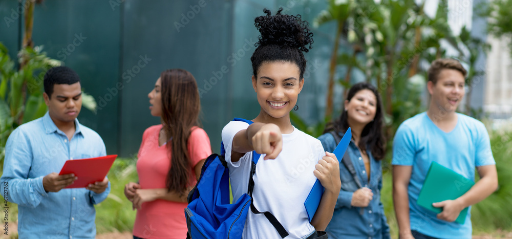 Excited indian female student with group of multi ethnic young adults