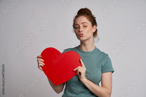 Young and beautiful woman with red heart