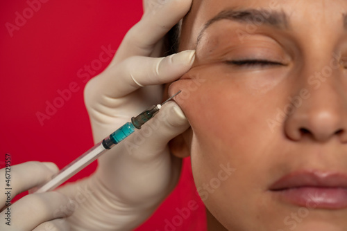 Portrait of a young woman on a face filler injection procedure
