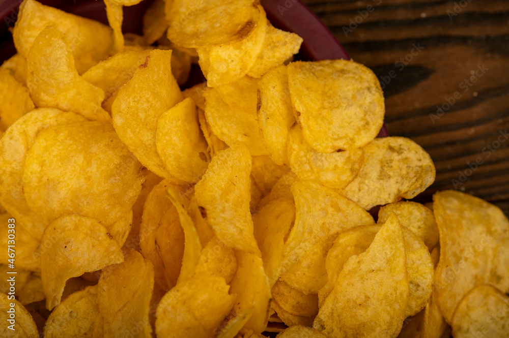Potato chips scattered on the table, close-up, selective focus.