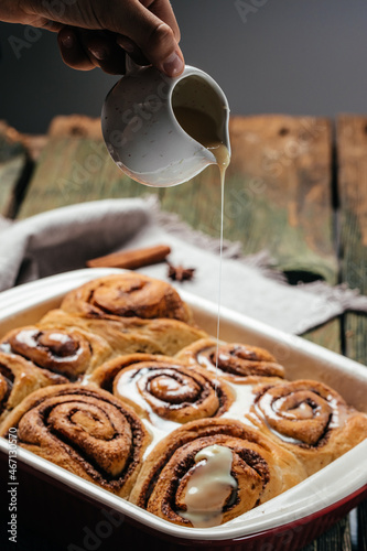 Baked sweet cinnamon rolls on a wooden table. Sinnabon buns rolls. swedish dessert photo