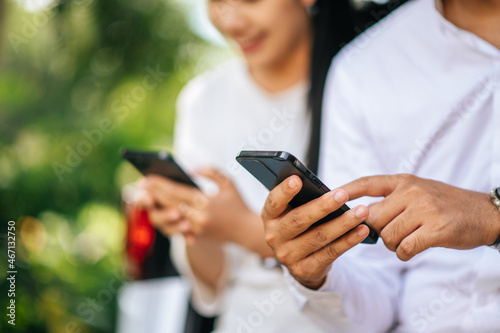 women and men sitting on mobile phones