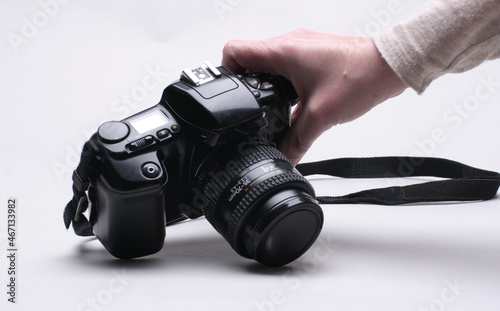 One Hand Picks Up A Vintage Film Camera