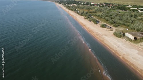 Aerial view of sandy beach during golden hour. Panoramic shot.