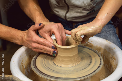 Master class on modeling of clay on a potter's wheel. In the pottery workshop.