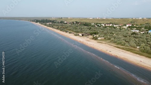 Aerial view of sandy beach during golden hour. Dolly shot.
