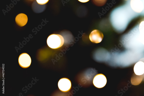 blurry dark background with lights. The brilliance of the city's night lights. Multicolored glitter vintage lights background. defocused. Festive background © Nataliya