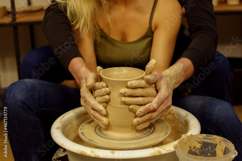 Master class on modeling of clay on a potter's wheel. In the pottery workshop.