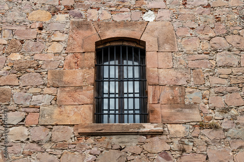 Old rock wall with vintage window for texture