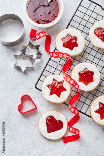 Classic Linzer Christmas Cookies with raspberry or strawberry jam on light background. photo