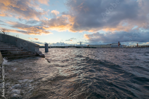 Raised water level in the Neva River due to strong winds. Arrow of Vasilievsky Island and Rastral Columns in the background. Beautiful clouds in the sunset sky. Saint-Petersburg  Russia.