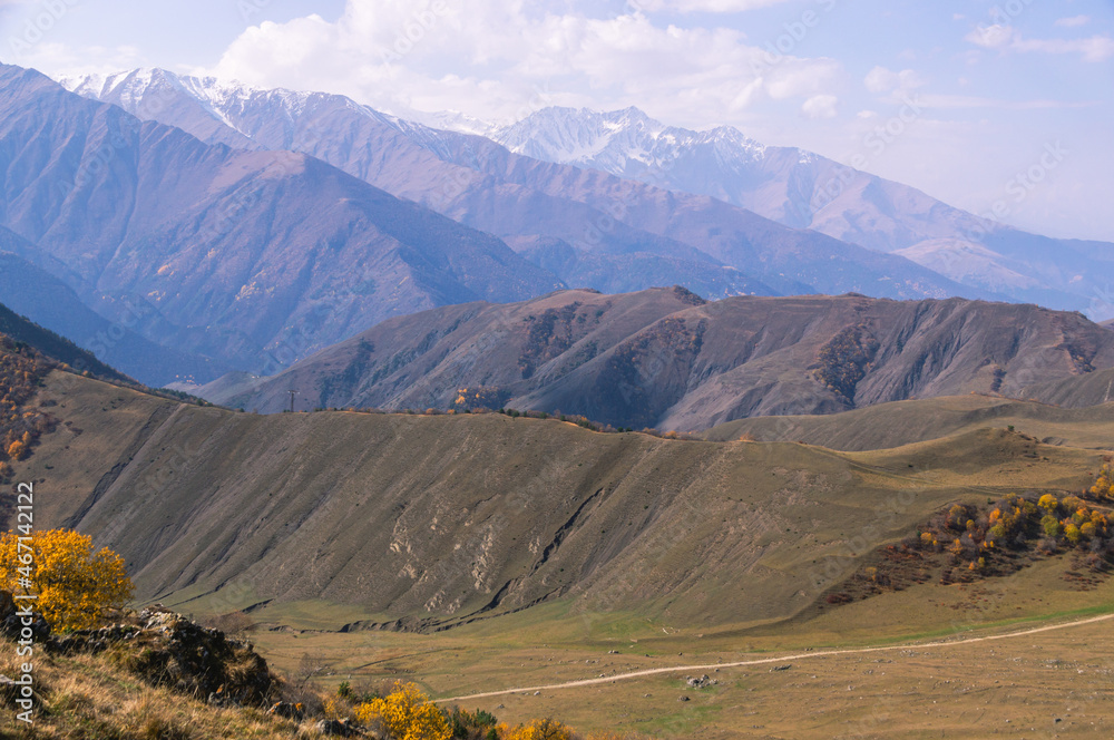 Rocks high in the mountains.. Mountain view on a clear autumn day. Mountains in Ingushetia. Landscape in the mountains in autumn. Rocks and trees in a mountainous area. Rocks high in the mountains.. Mountain view on a clear autumn day. Mountains in Ingushetia. Landscape in the mountains in autumn. Rocks and trees in a mountainous area.
