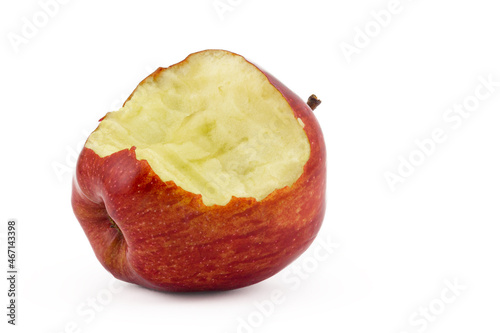 Close-up isolated bitten red apple lies on a white background. Side bitten off