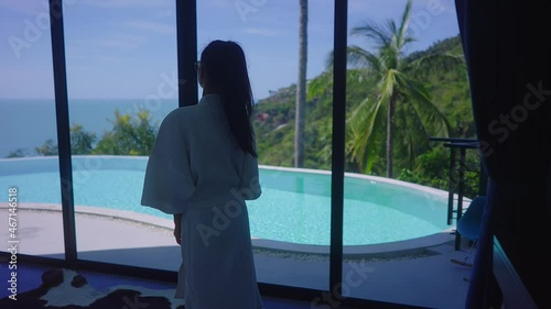 Pretty Girl In Swimming Suit In Luxurious Villa Walking Towards Infinity Pool 