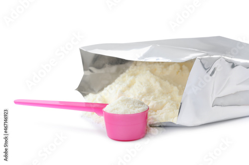 Bag of powdered infant formula and scoop on white background. Baby milk