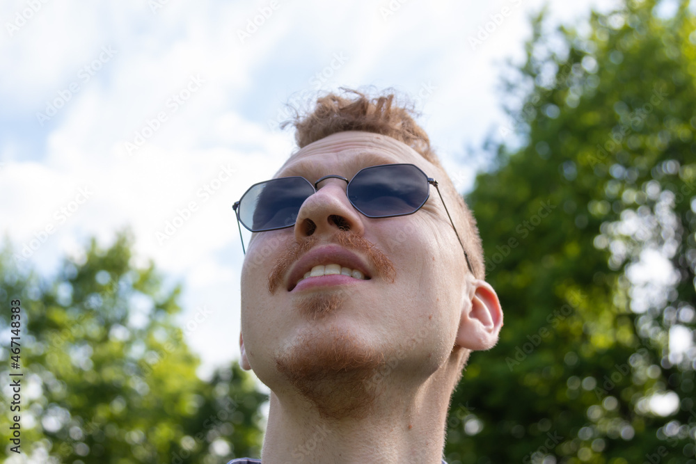 a man looks up at the sky in sunglasses a man looks up at the sky in sunglasses