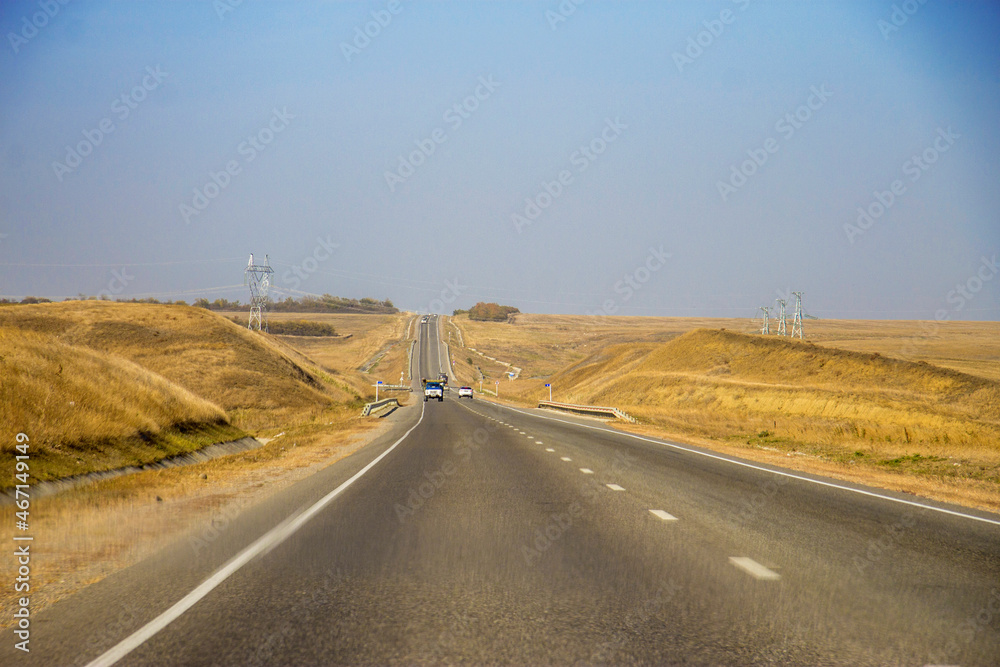 Road and moving cars at daytime and blue sky over Road and moving cars at daytime and blue sky over
