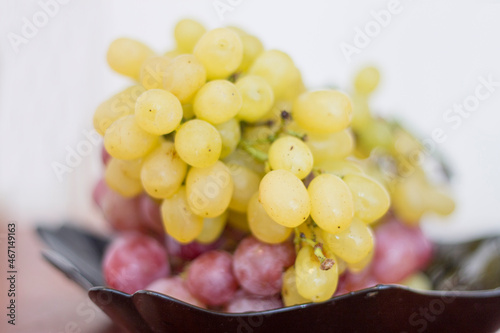 Red and White wine bunch of grapes in the black plate