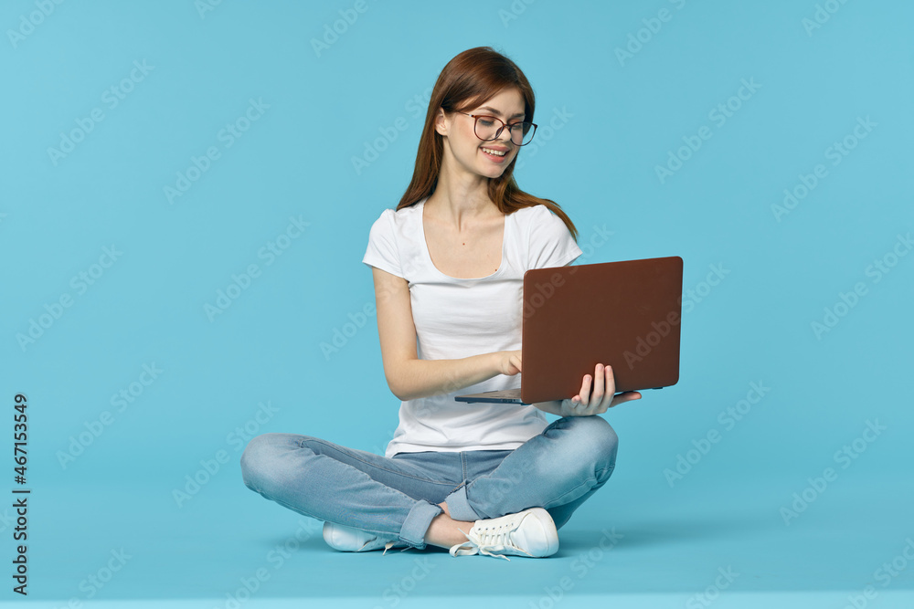 woman with laptop sitting on the floor learning student technology blue background woman with laptop sitting on the floor learning student technology blue background