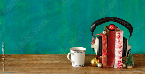 Giving audio books for christmas with christmas decoration,vintage headphones and cup of coffee.Gift,present,christian holiday concept, copy space.