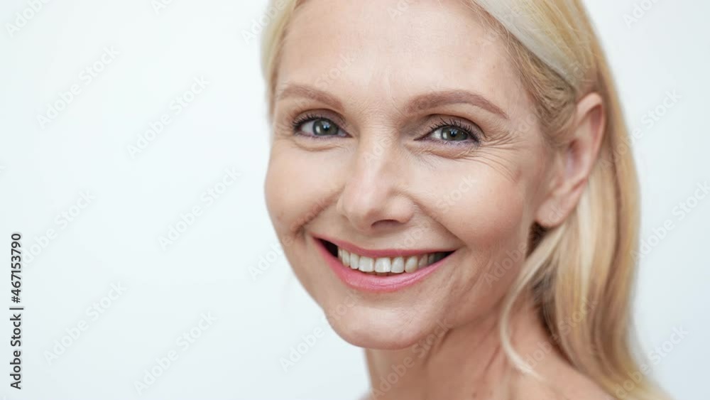 Profile view of retired lady turn look camera touch wrinkled facial skin Profile view of retired lady turn look camera touch wrinkled facial skin