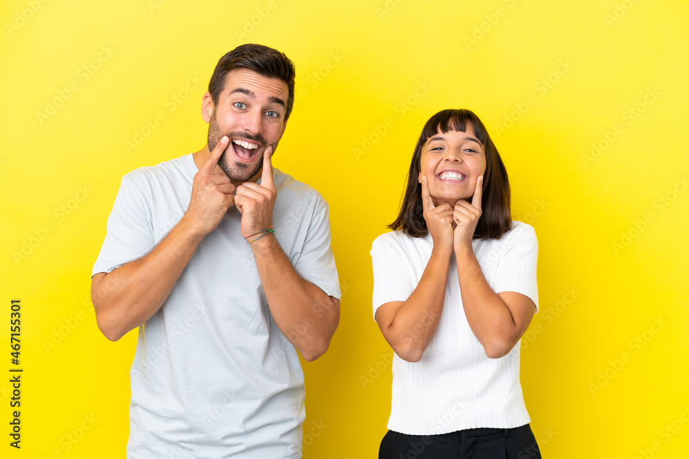 Young couple isolated on yellow background smiling with a happy and pleasant expression Young couple isolated on yellow background smiling with a happy and pleasant expression