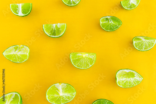 Lemon slices on yellow background top view.