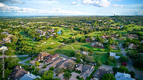 A bird's-eye view of the surroundings of residential buildings and beautiful green fields. Houston, Texas, USA. Development of suburban housing construction. general plan
