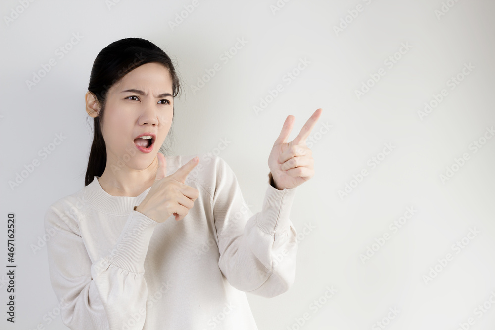Asian woman with awesome face and open mouth are indicate and pointing to blank space for promotion and advertisement and a present text. Asian woman with awesome face and open mouth are indicate and pointing to blank space for promotion and advertisement and a present text.