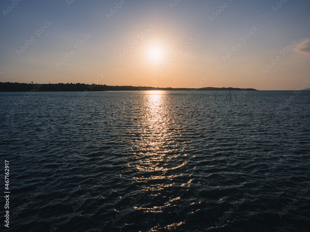 Scenic view of peaceful blue water bay with island silhouette in evening before sunset. Koh Mak Island, Trat, Thailand. Scenic view of peaceful blue water bay with island silhouette in evening before sunset. Koh Mak Island, Trat, Thailand.