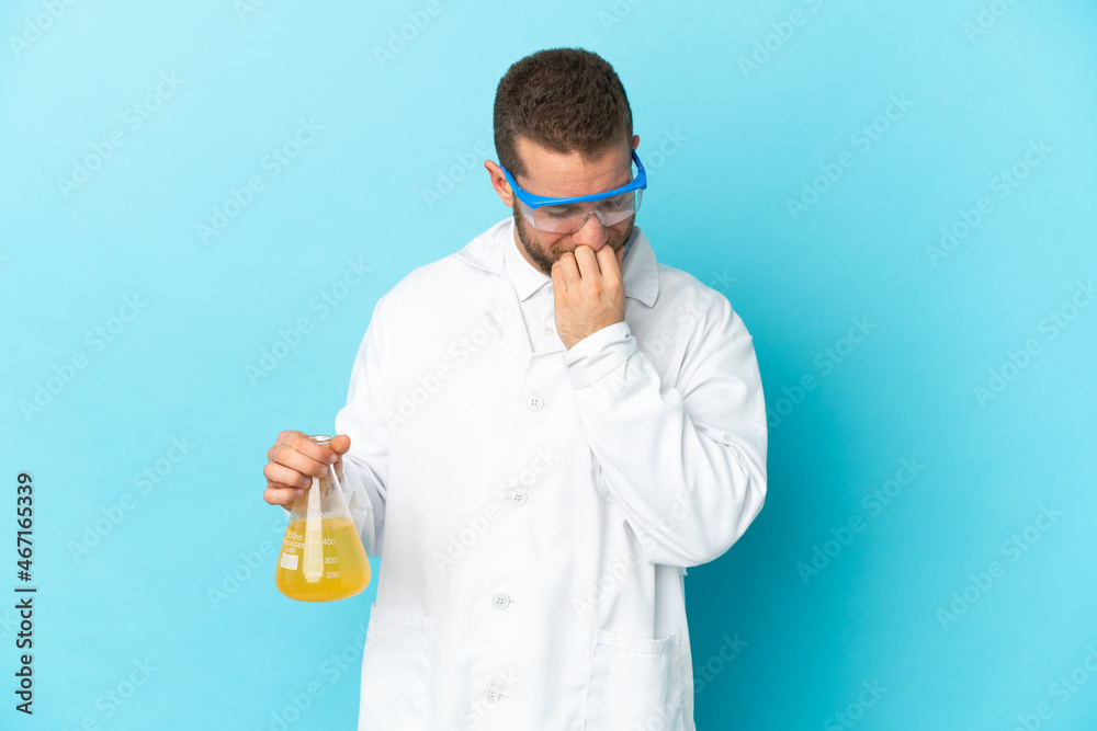 Young caucasian scientific man isolated on blue background having doubts Young caucasian scientific man isolated on blue background having doubts