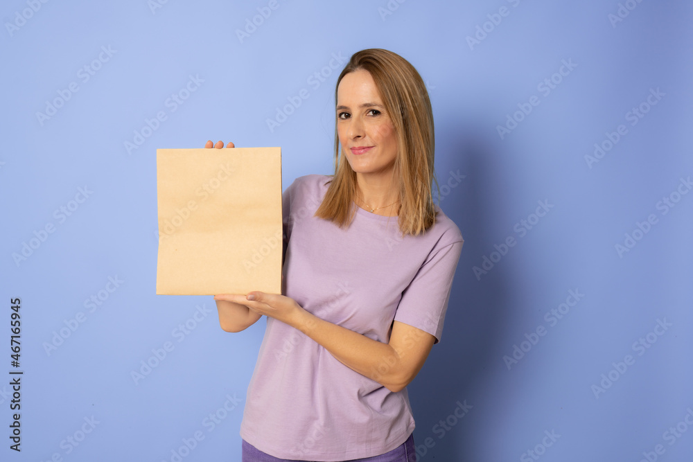 Close up Portrait young beautiful attractive woman smiling with shopping bag. Purple background. Copy Space. Close up Portrait young beautiful attractive woman smiling with shopping bag. Purple background. Copy Space.