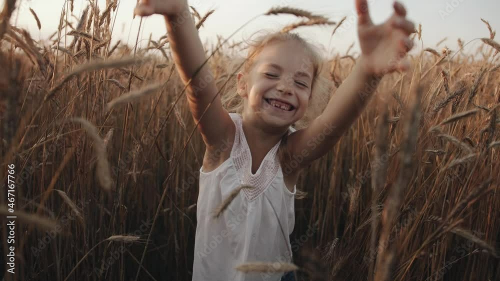 A joyful little girl with her front teeth falling out is goes among the