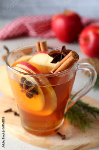 Aromatic hot mulled cider on wooden board