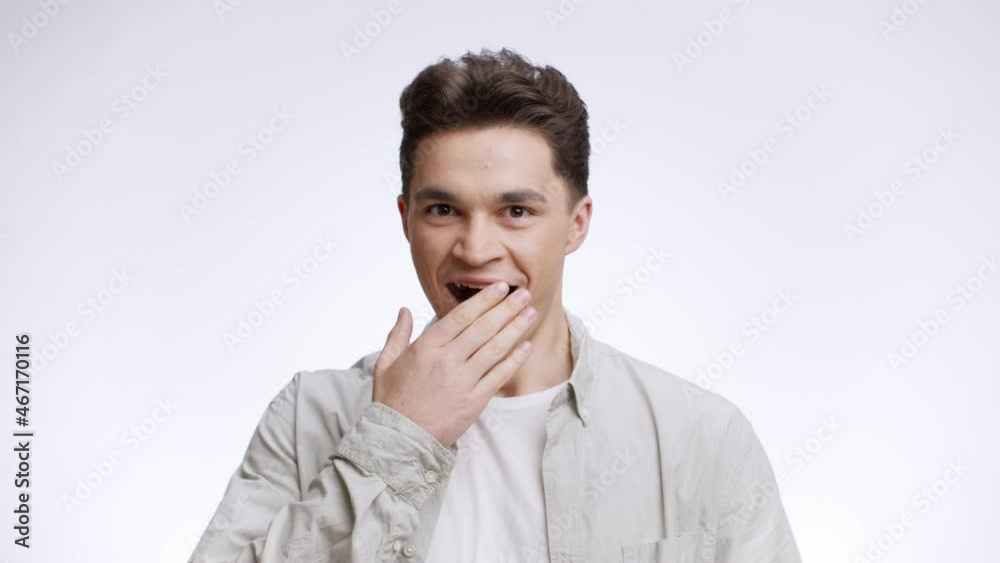 Studio portrait of surprised young guy feeling stunned and amazed, spreading hands and touching mouth in happy amazement Studio portrait of surprised young guy feeling stunned and amazed, spreading hands and touching mouth in happy amazement