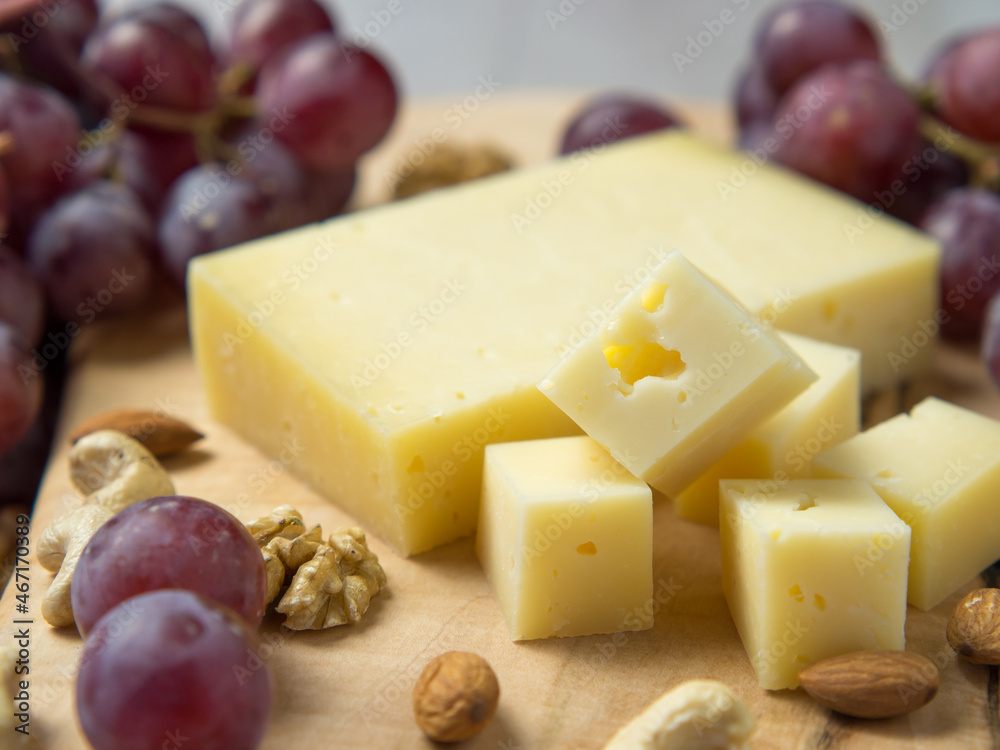 cheese with holes, grapes, nuts, Snack table with appetizers