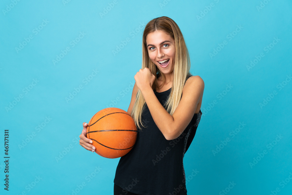 Young woman playing basketball  isolated on white background celebrating a victory