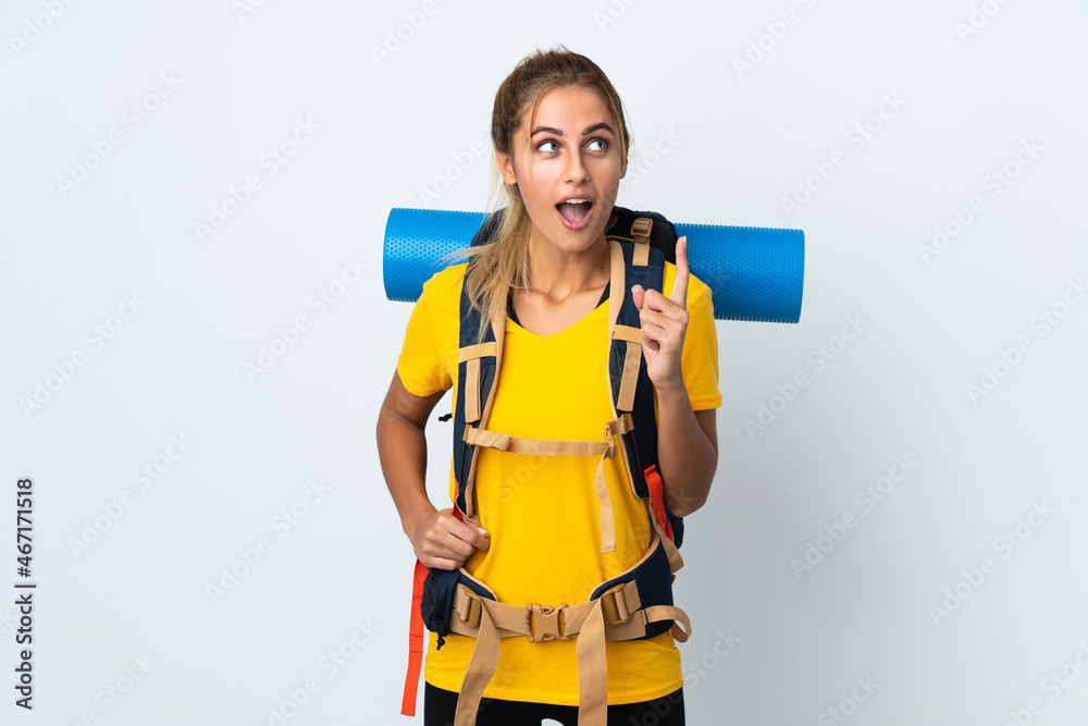Young mountaineer woman with a big backpack isolated on white background thinking an idea pointing the finger up Young mountaineer woman with a big backpack isolated on white background thinking an idea pointing the finger up