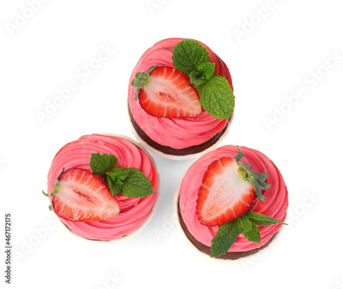 Sweet cupcakes with fresh strawberries on white background, top view